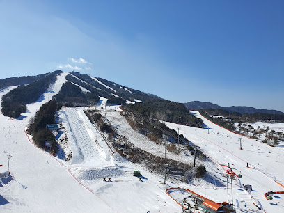 View of Mountain Creek ski resort in Vernon New Jersey highlighting a bustling winter sports scene. Snow-covered slopes a ski lift and various winter sports activities are visible.
