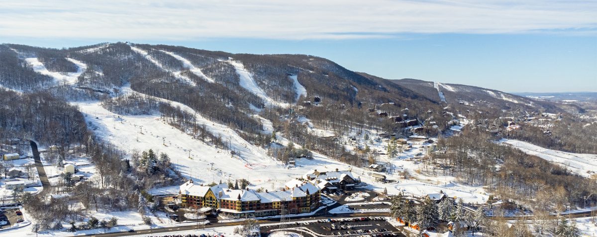 A ski resort at Mountain Creek, Vernon, New Jersey featuring snow-covered slopes and a ski lift, capturing a captivating winter sports scene amidst stunning winter scenery.