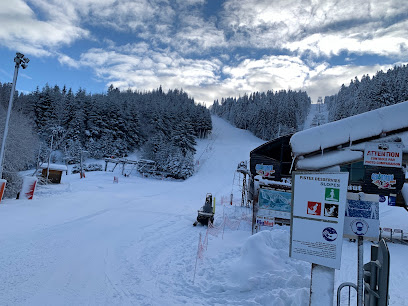 View of Welli Hilli Park Ski Resort in South Korea, showcasing a winter sports scene with a ski lift leading up to a chalet against a snowy backdrop.