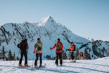 Group of skiers including a family enjoying winter sports at Roc d'Enfer ski resort in Mont Blanc Saint-Jean-d'Aulps France.