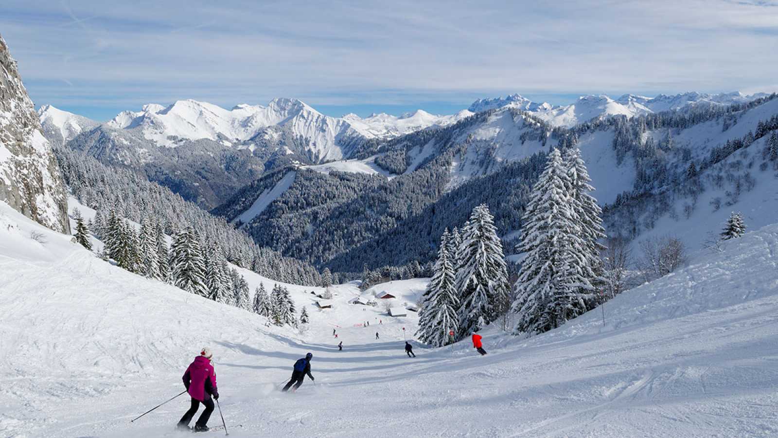 Roc d'Enfer in France - a group of people skiing down a snowy slope.