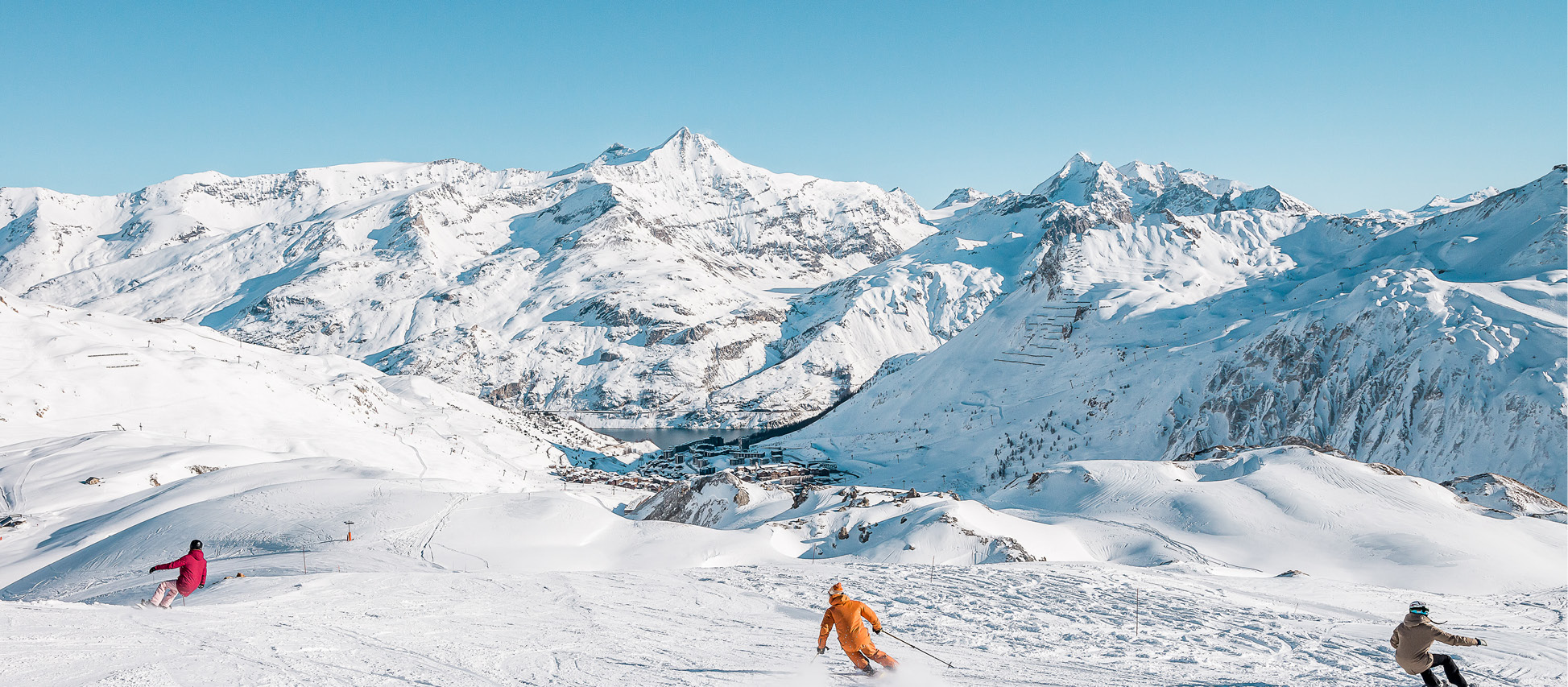 Tignes in France - a group of people skiing down a snow covered mountain.