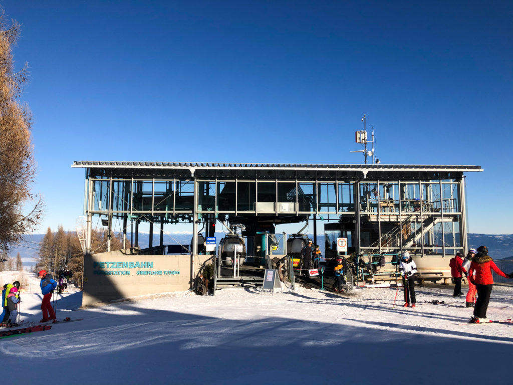 Petzen in Austria - a group of people standing on top of a ski slope.