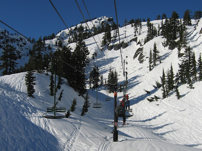 A ski lift traverses the snowy slope at the Petzen ski resort in Austria. Skiers enjoy the winter sports scene on a picture-perfect day.