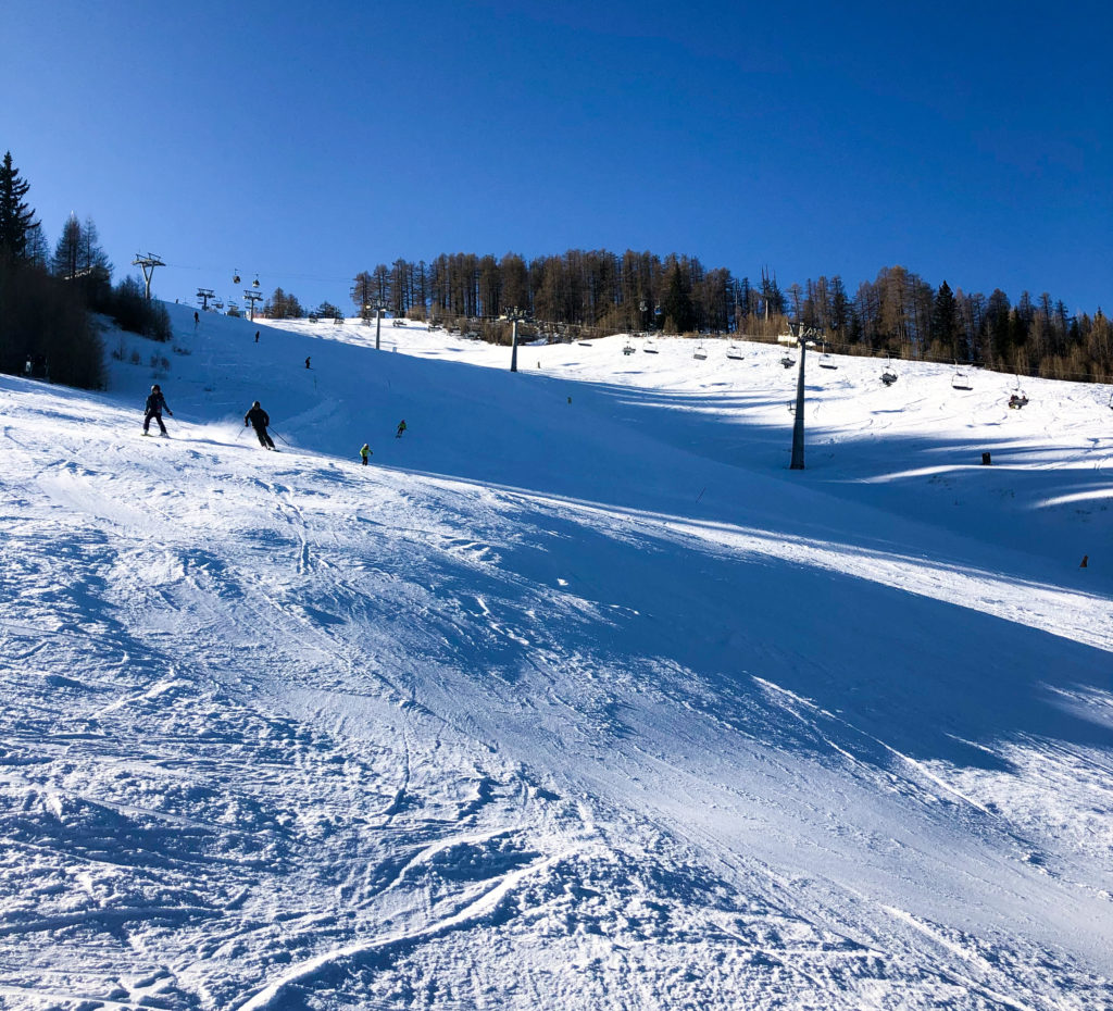 Petzen in Austria - a group of people riding down a snow covered slope.