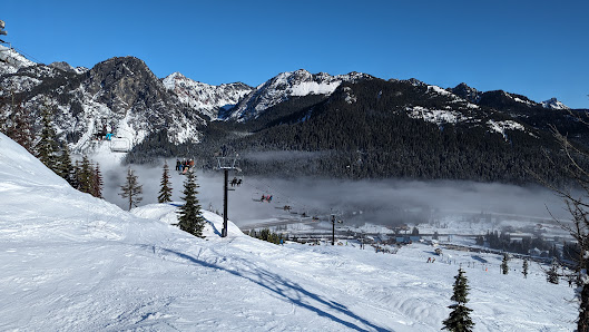 View of The Summit at Snoqualmie ski resort in Snoqualmie Pass Washington featuring a chalet and ski lift a popular winter sports destination with snow-covered slopes.