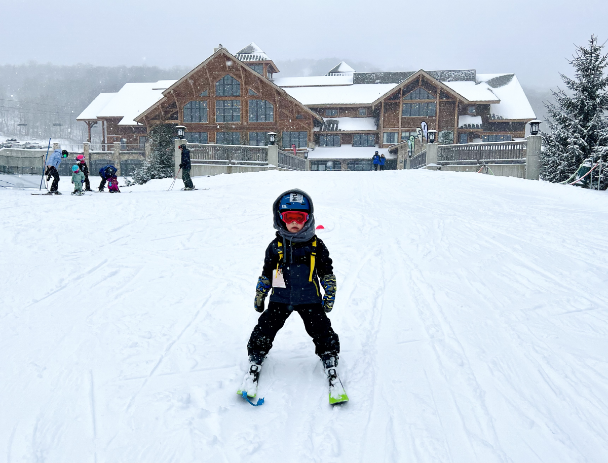 The Hermitage Club, Mt Haystack in USA - a small child on skis in the snow.