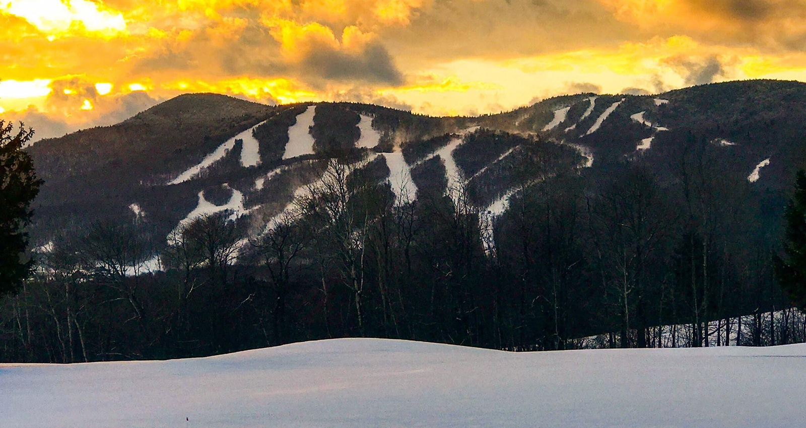 The Hermitage Club, Mt Haystack in USA - a person on a snowboard in the snow.