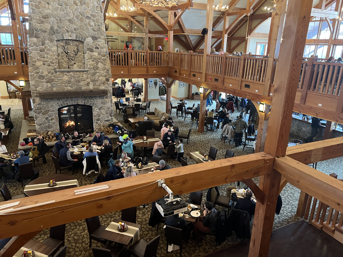 The Hermitage Club, Mt Haystack in USA - a group of people sitting at tables in a restaurant.