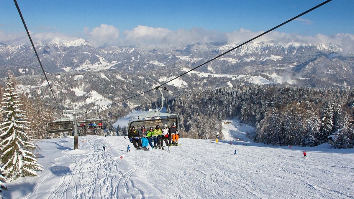 Cerkno in Slovenia - a ski lift going up a snowy mountain.