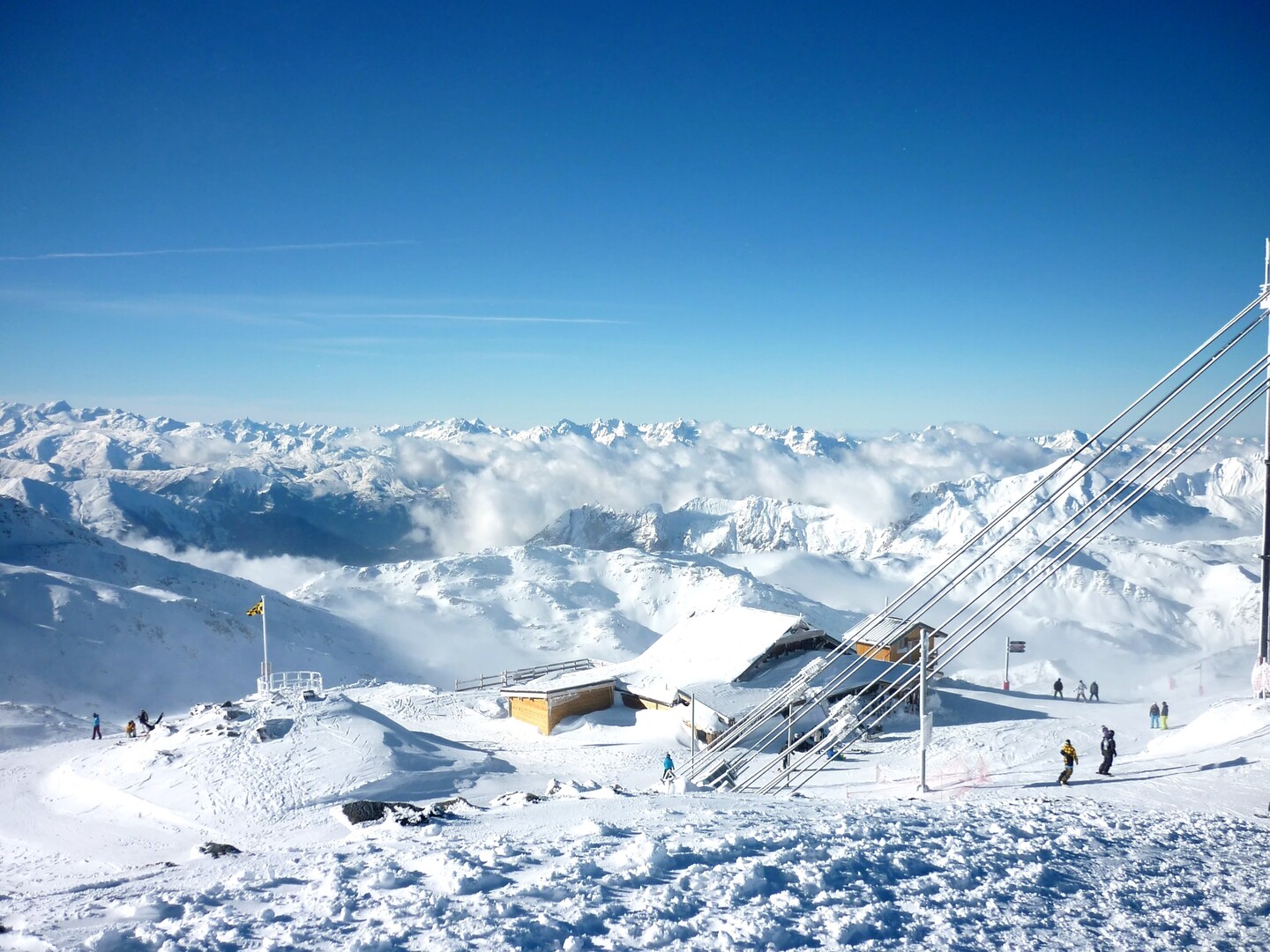 Les 3 Vallées in France - a group of people standing on top of a mountain.