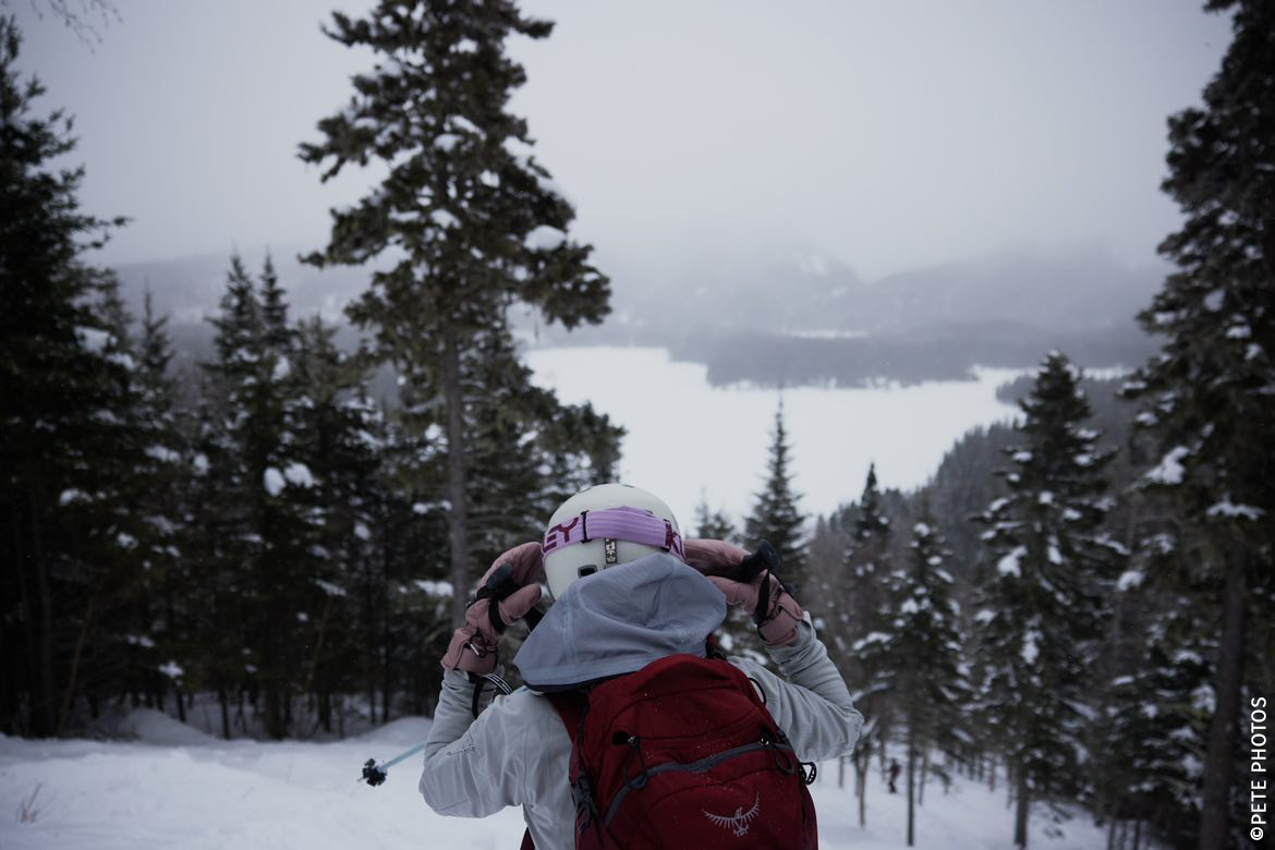 Snowboarder and skier enjoying winter sports amid a stunning winter scenery at Mont Edouard L'Anse-Saint-Jean Quebec Canada. Prominent are the snow-covered landscape and the beauty of the winter season.