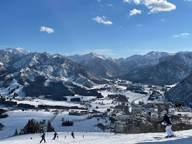 Vibrant winter scene at the Iwappara ski resort in Honshu, Japan, showcasing captivating snowfall and skiers enjoying the slopes.
