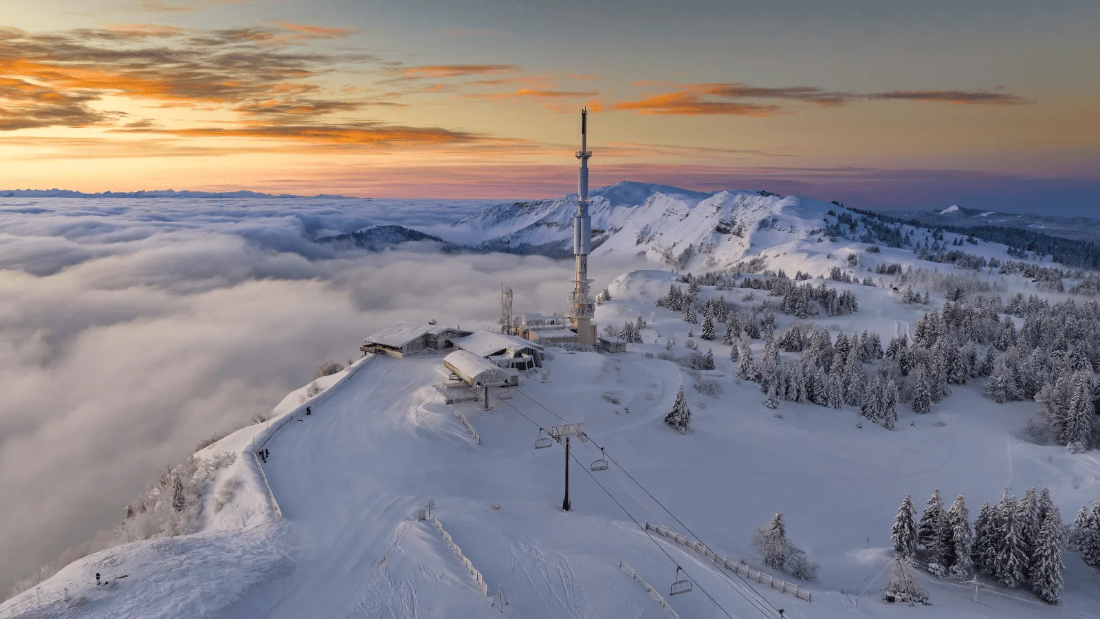 Mijoux - La Faucille in France - a ski slope covered in snow at sunset.