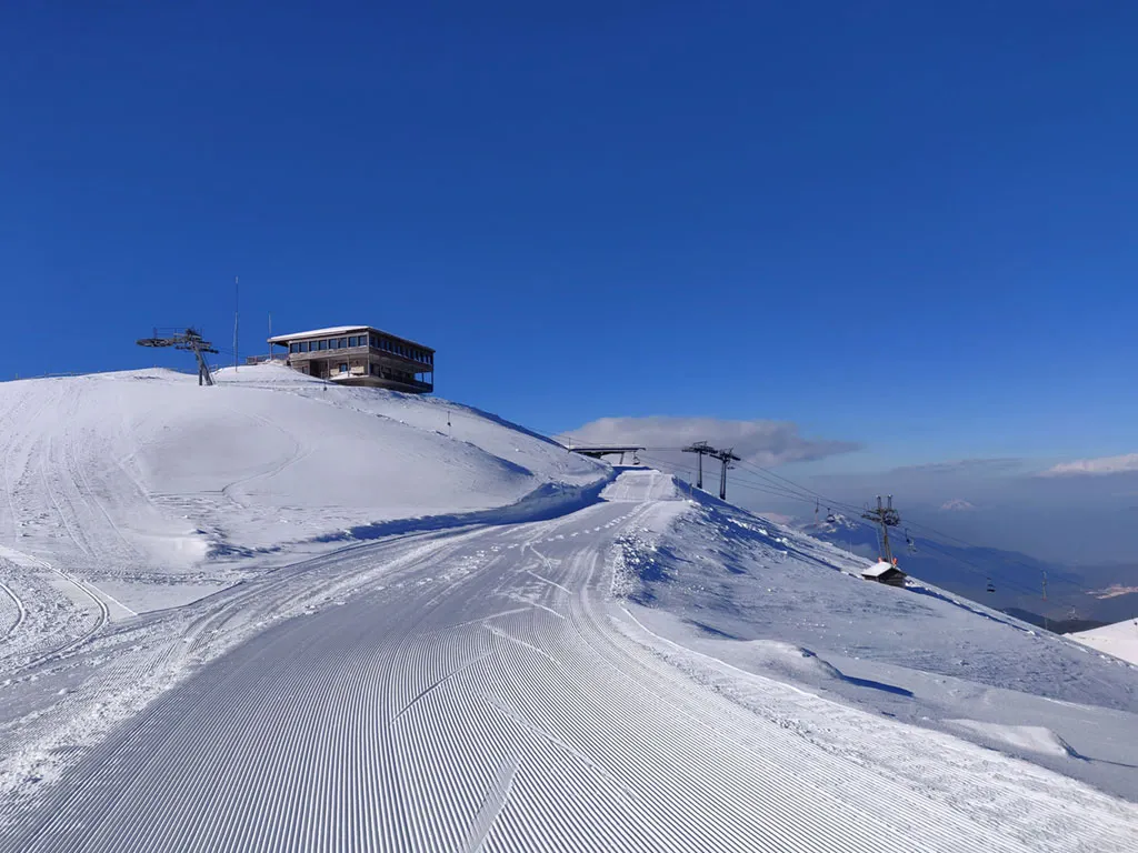 Falakro in Greece - a snow covered mountain with a ski lift in the background.