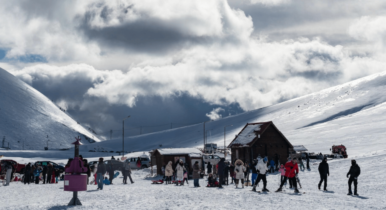 Falakro in Greece - a group of people standing on top of a snow covered slope.