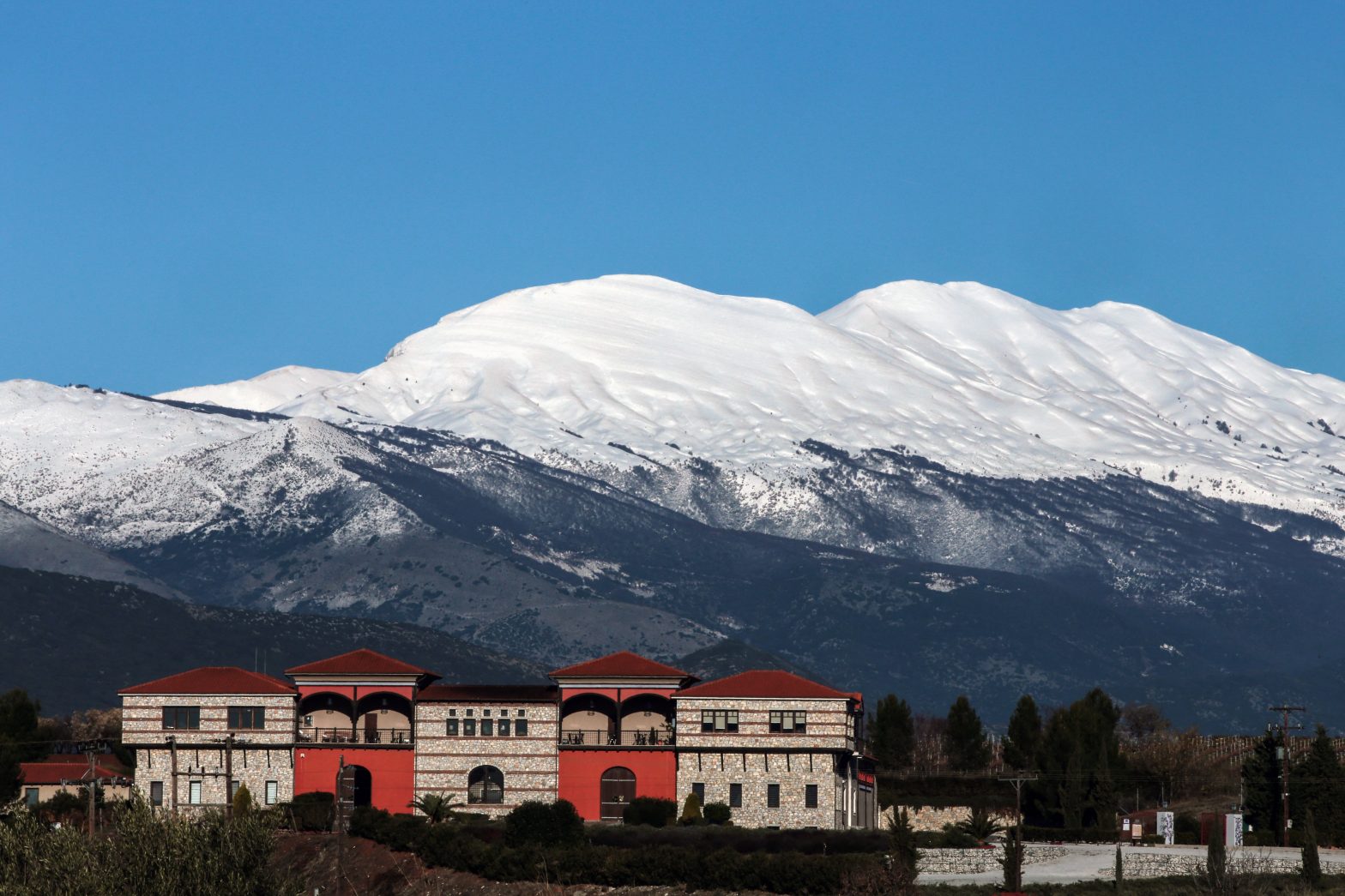 Falakro in Greece: a red building with a mountain in the background.