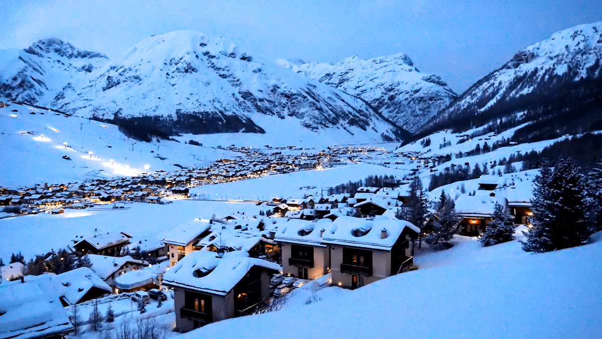 Cima Piazzi San Colombano in Italy - a view of a snowy town at night.