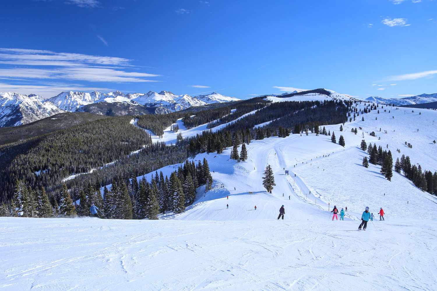 Vail in USA - a group of people skiing down a mountain.