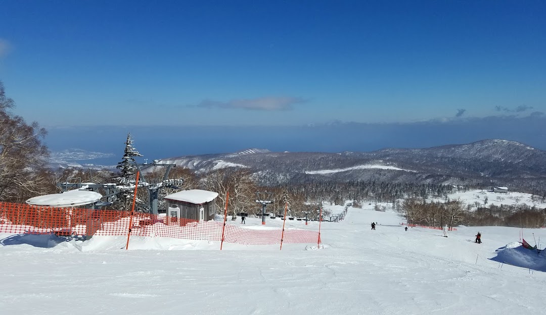 Winter sports scene at Sapporo Kokusai – Jozankei Kogen ski resort in Sapporo, Japan, featuring a stunning winter landscape with a chalet and ski facilities.