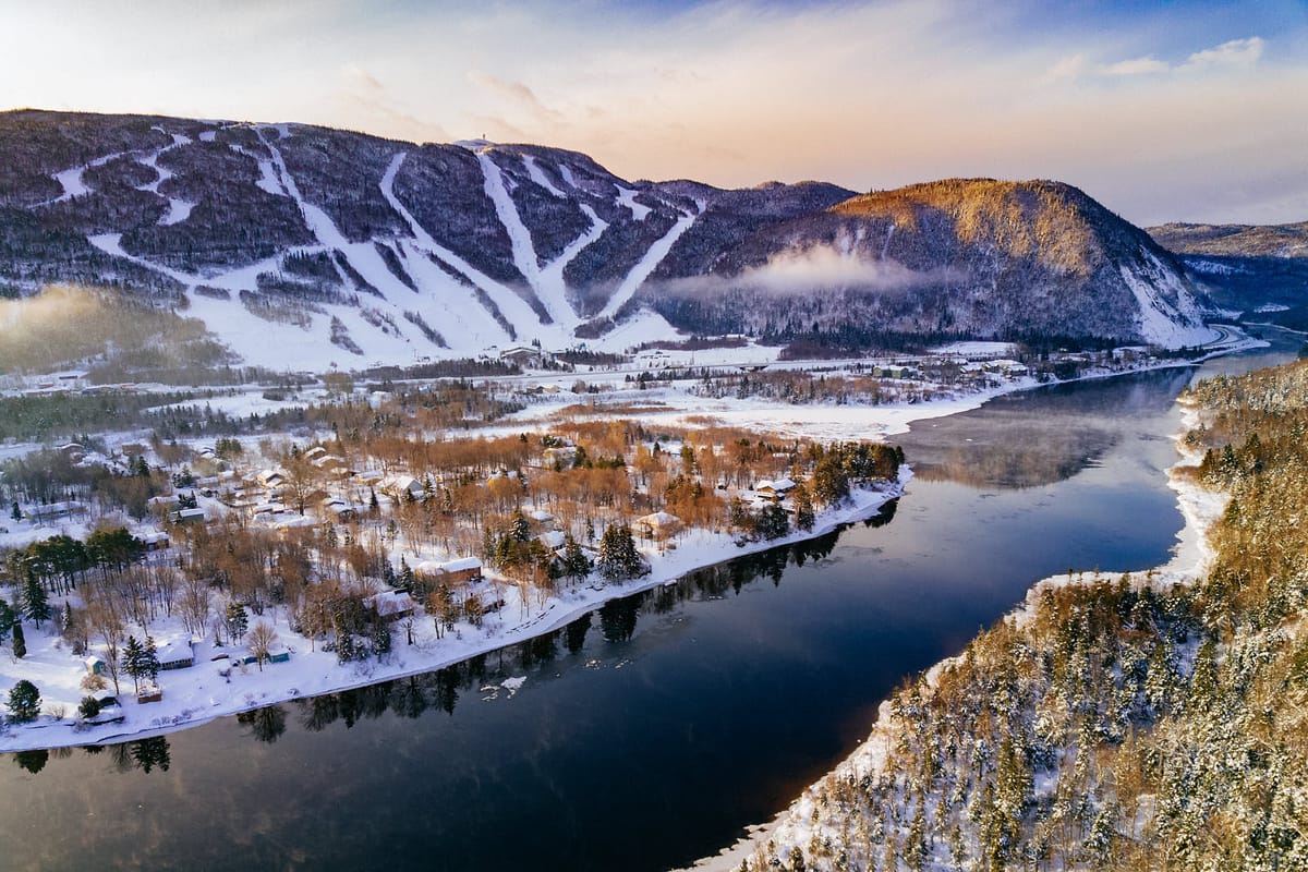 Marble Mountain in Canada - a lake surrounded by snow covered mountains.