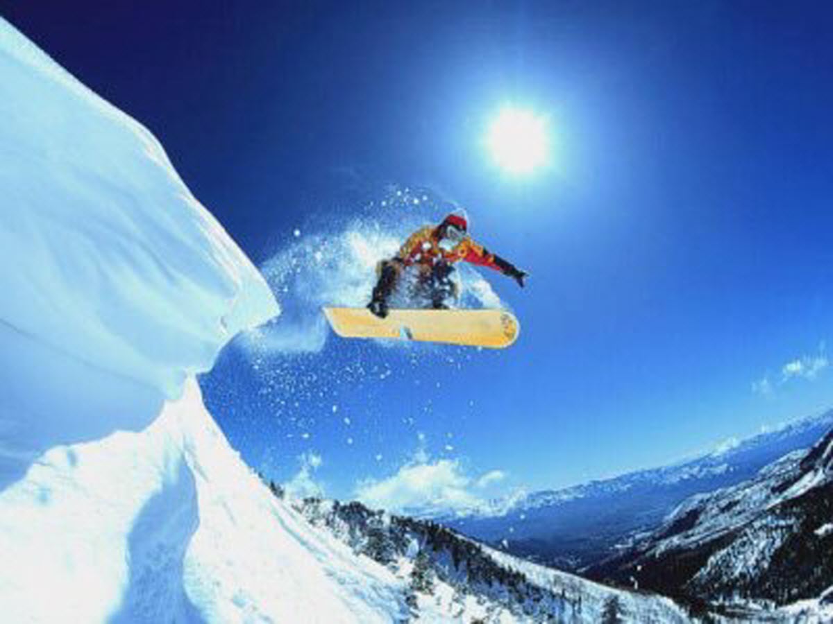 Mont Orignal in Canada - a snowboarder doing a trick in the air.