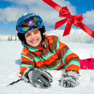 A snowboarder and skier enjoying a winter sports scene at Mont Orignal in Quebec, Canada. A scenic winter landscape with an inviting chalet in the distance.