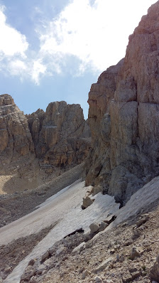 A stunning view of the rugged Gran Sasso mountain range in Abruzzo Italy with a charming chalet nestled against its slopes. A mountain bike suggests outdoor adventure in this breathtaking landscape.