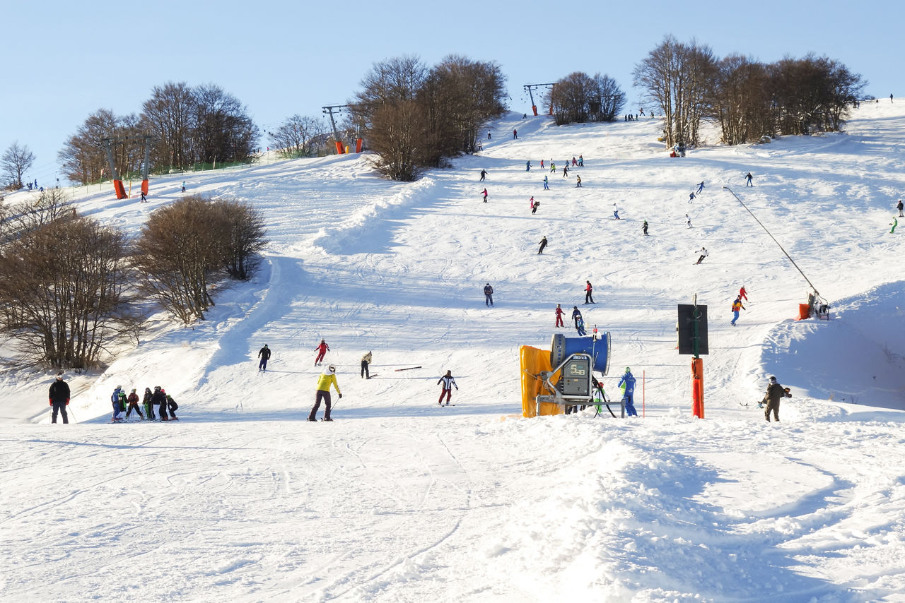 Gran Sasso in Italy - a group of people skiing down a snowy hill.
