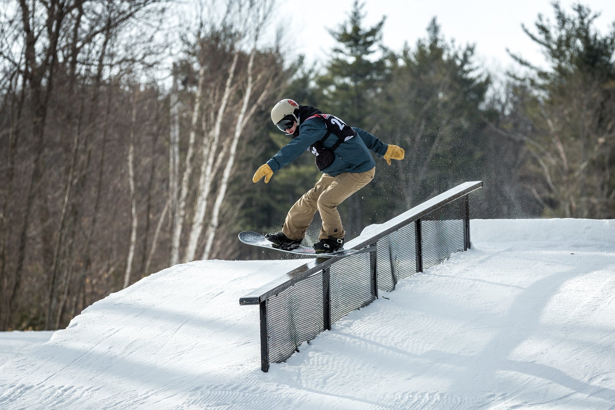 Wachusett Mountain Ski Area in USA - a man riding a snowboard down a snowy slope.