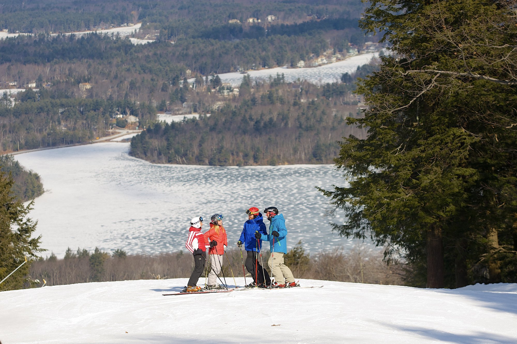 Wachusett Mountain Ski Area in USA - a group of people standing on top of a snowy hill.