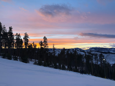 Winter sports scene at Granby Ranch in Colorado, USA. The image showcases breathtaking winter scenery with snowy mountains and a busy ski resort.