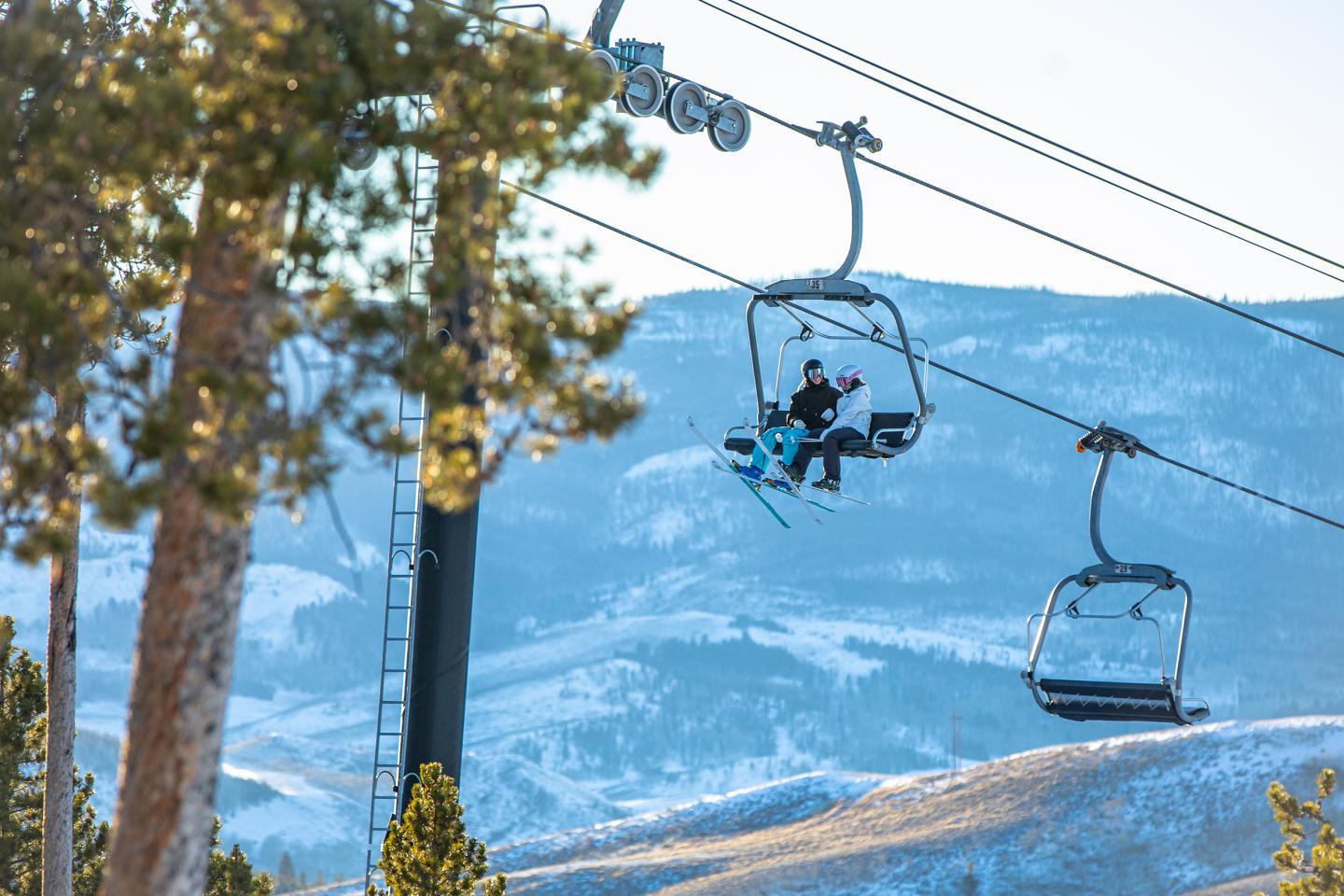 Granby Ranch in USA - a person riding a ski lift in the mountains.