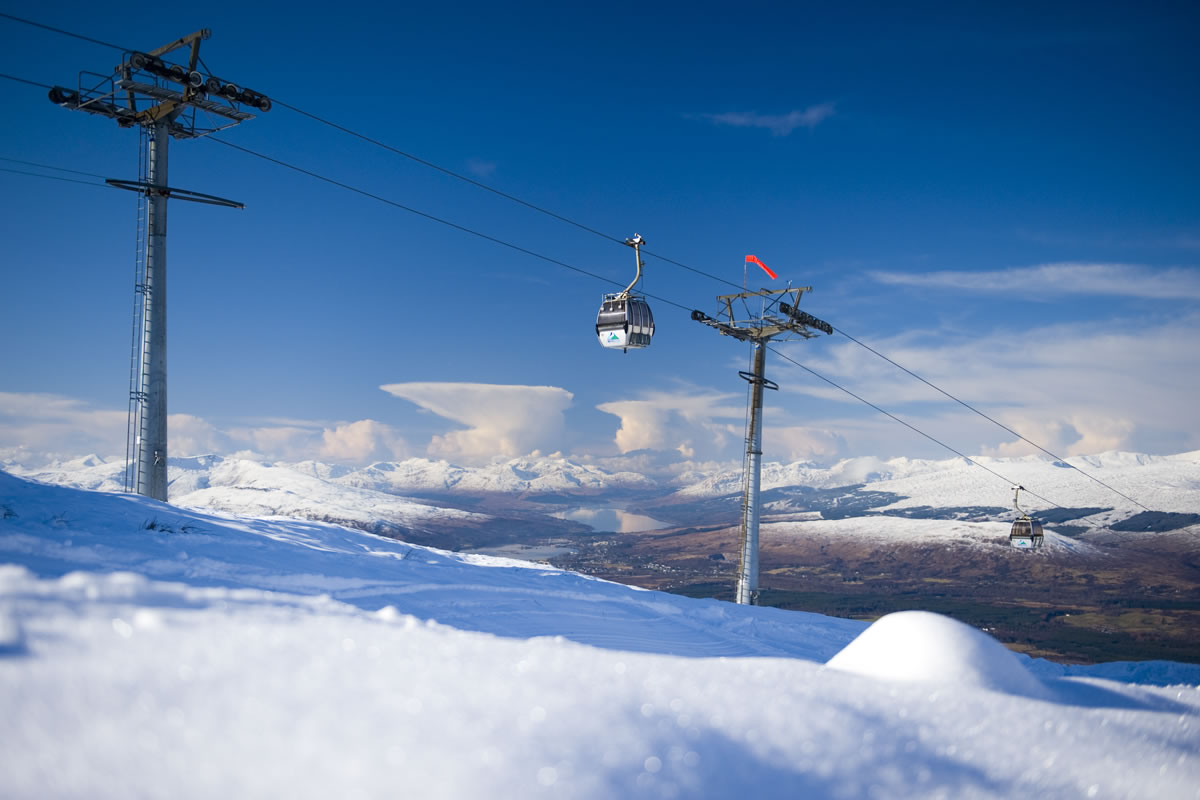 Nevis Range in United Kingdom - a ski lift going up a snowy hill.