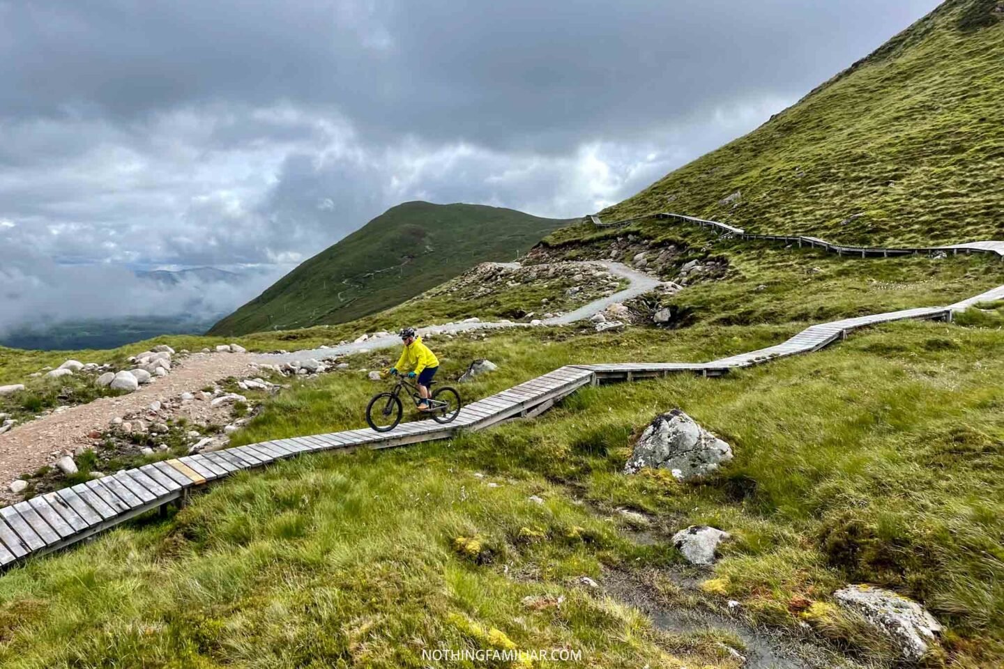 Nevis Range in United Kingdom - a person riding a mountain bike on a wooden path.