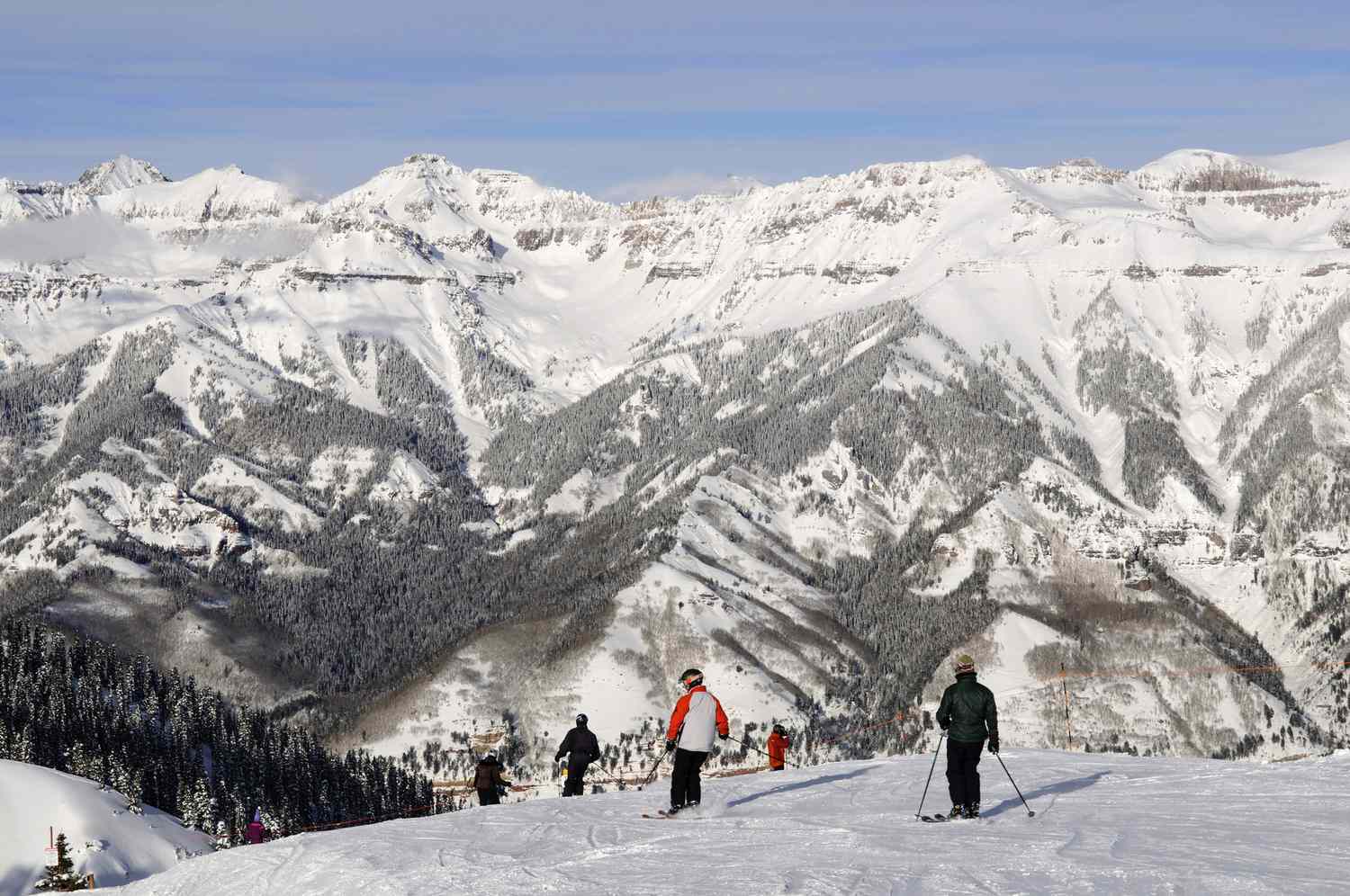 Telluride in USA - a group of people standing on a snow covered mountain.