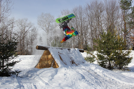 A snowboarder glides down the frosty slopes of Titus Mountain in The Adirondacks Malone New York enjoying the thrill of winter sports amidst the scenic beauty of nature.