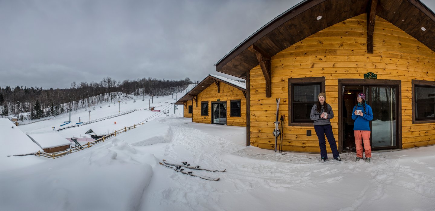 Titus Mountain in USA - a man and woman standing in front of a cabin.