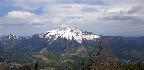 View of the majestic Gemeindealpe mountain in Mitterbach Austria with a quaint chalet nestled amongst the snowy peaks.