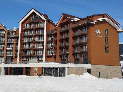 A picturesque view of Goderdzi ski resort in Danisparauli Adjara Georgia featuring a chalet and lodge nestled amidst snow-covered landscape. Ideal setting for winter sports.