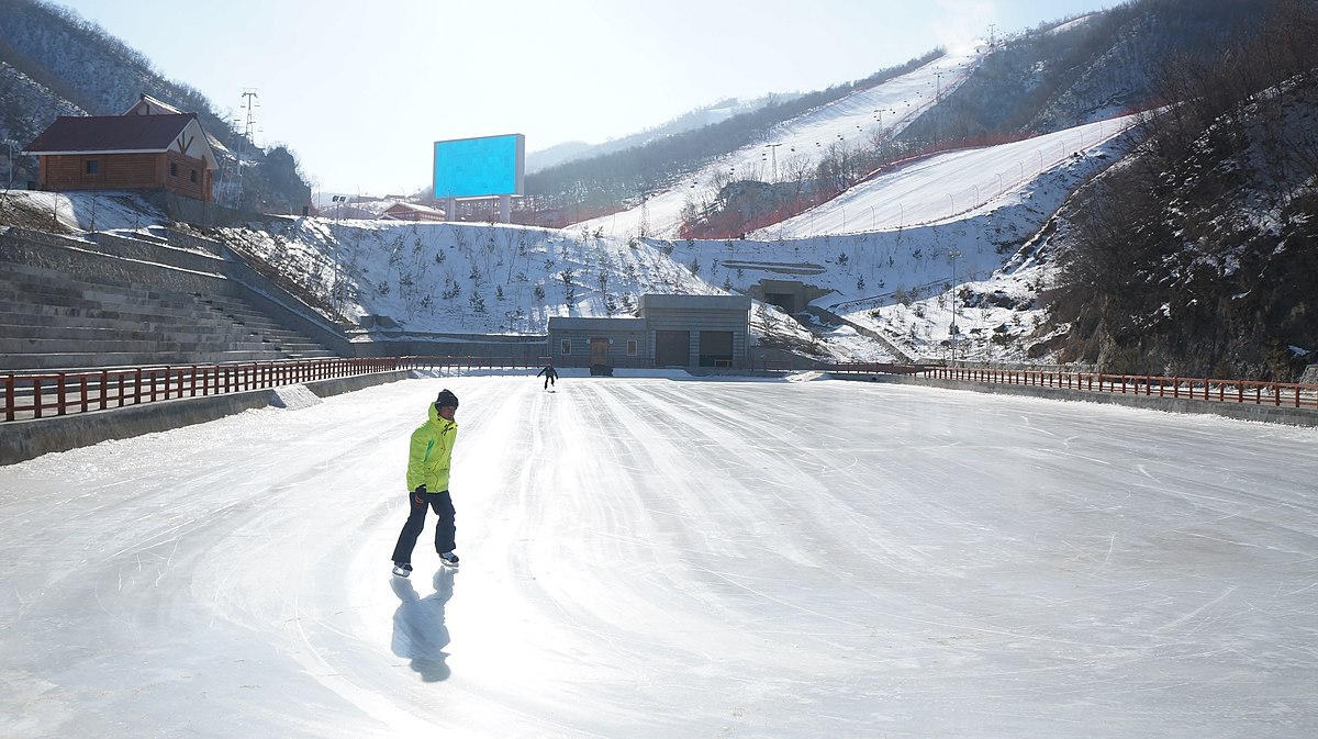 Masik Pass in North Korea - a person on a snowboard going down a hill.