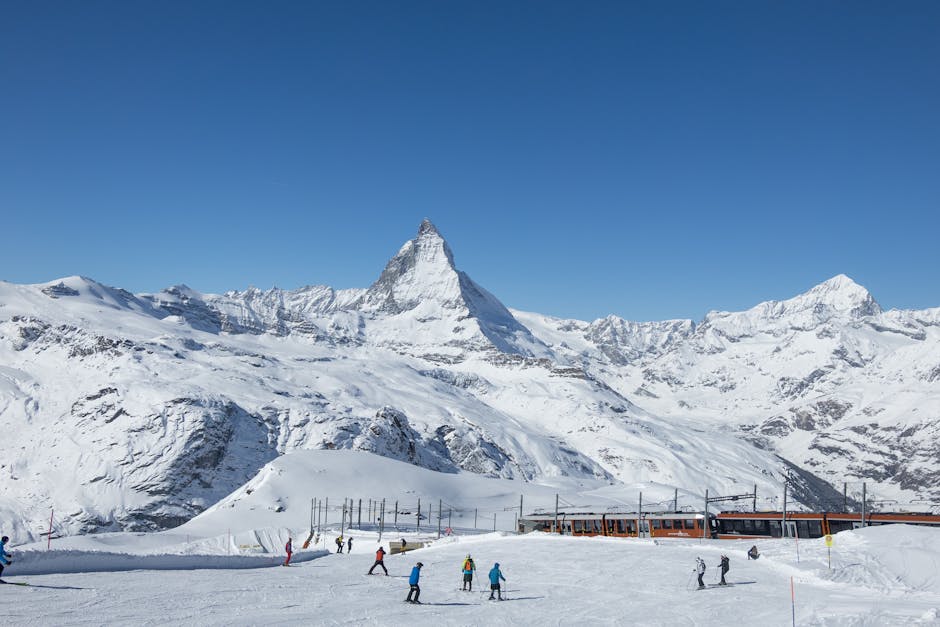 Zermatt Ski Resort in Switzerland - a group of people skiing down a snowy slope.