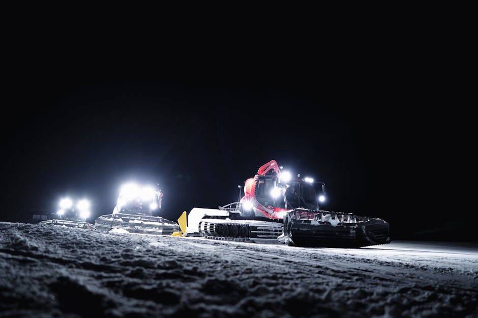 Zermatt Ski Resort in Switzerland - two snowmobiles in the snow at night.