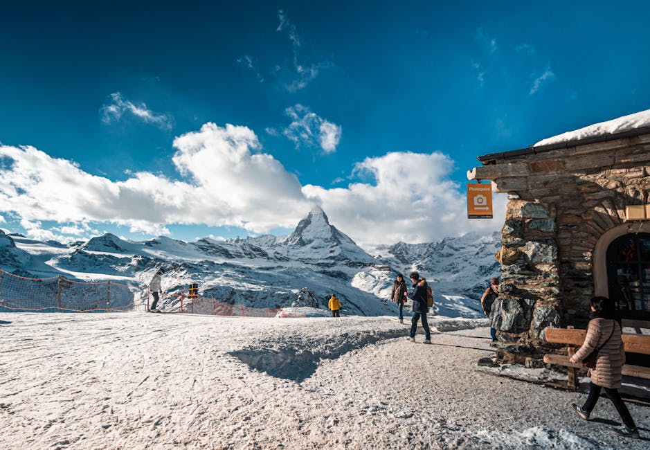 Zermatt Ski Resort in Switzerland - a group of people standing on top of a mountain.