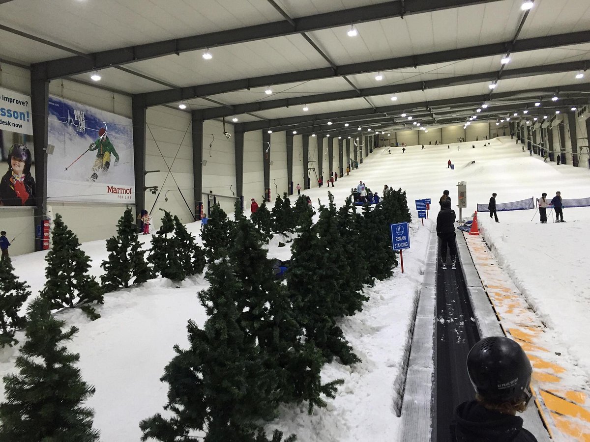 Snowplanet – Silverdale in New Zealand - a group of people riding down a snow covered slope.