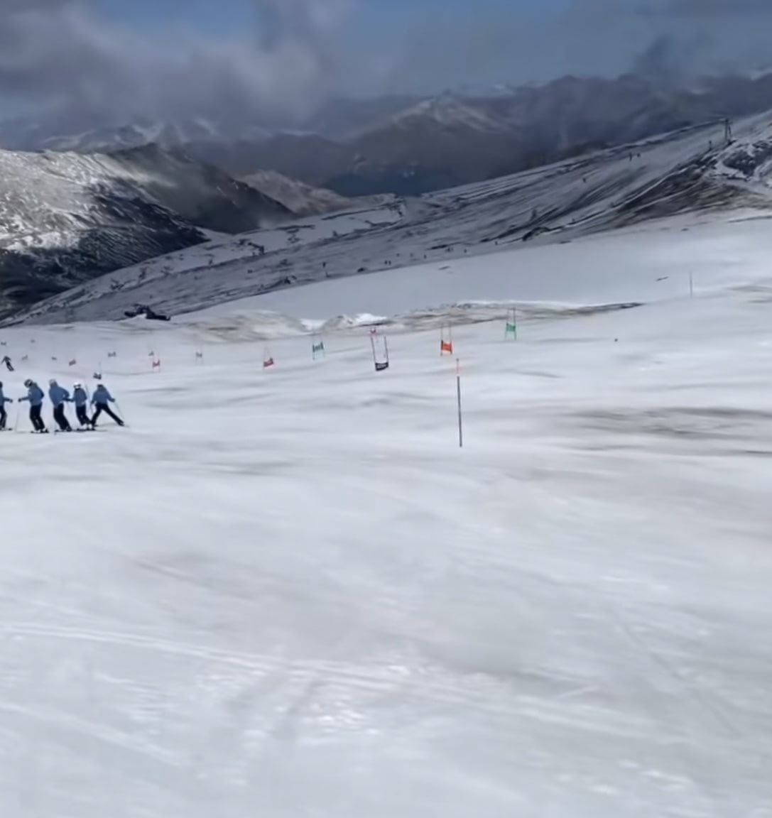 Passo dello Stelvio in Italy - a group of people skiing down a snow covered mountain.