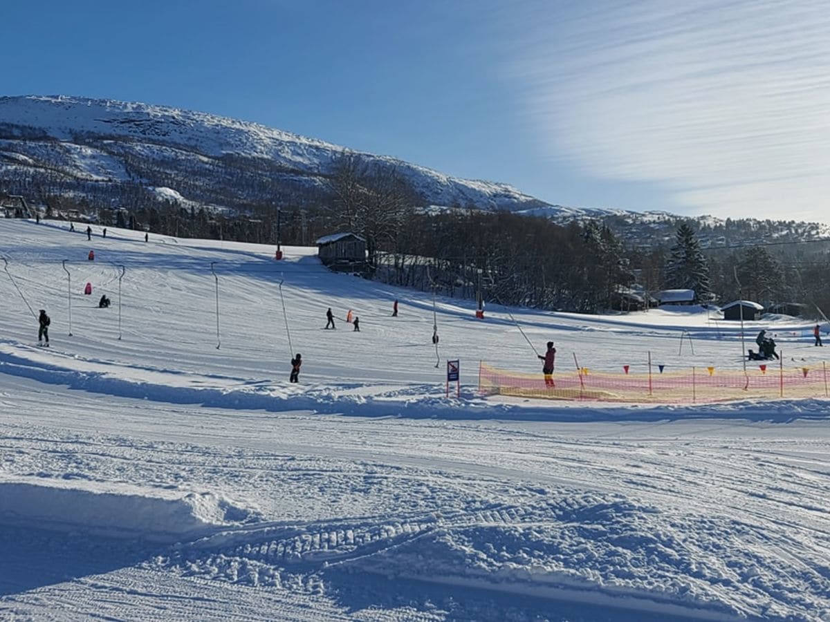 Bjorli in Norway - a group of people skiing down a snow covered slope.