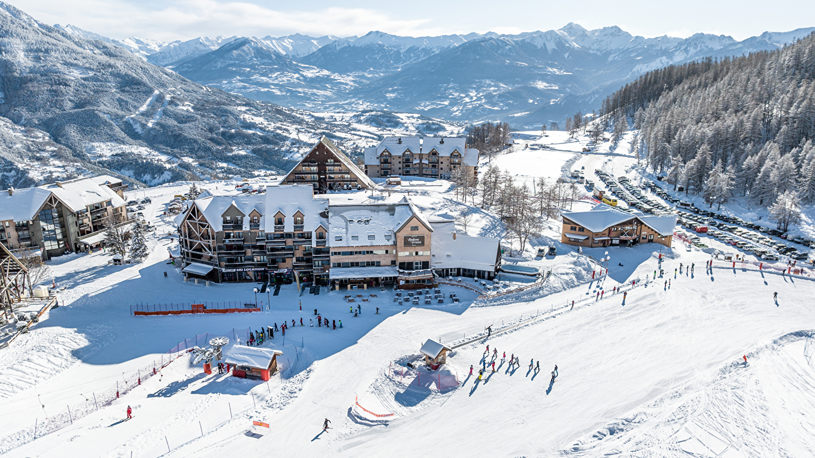 Réallon in France - a group of people skiing down a snowy hill.