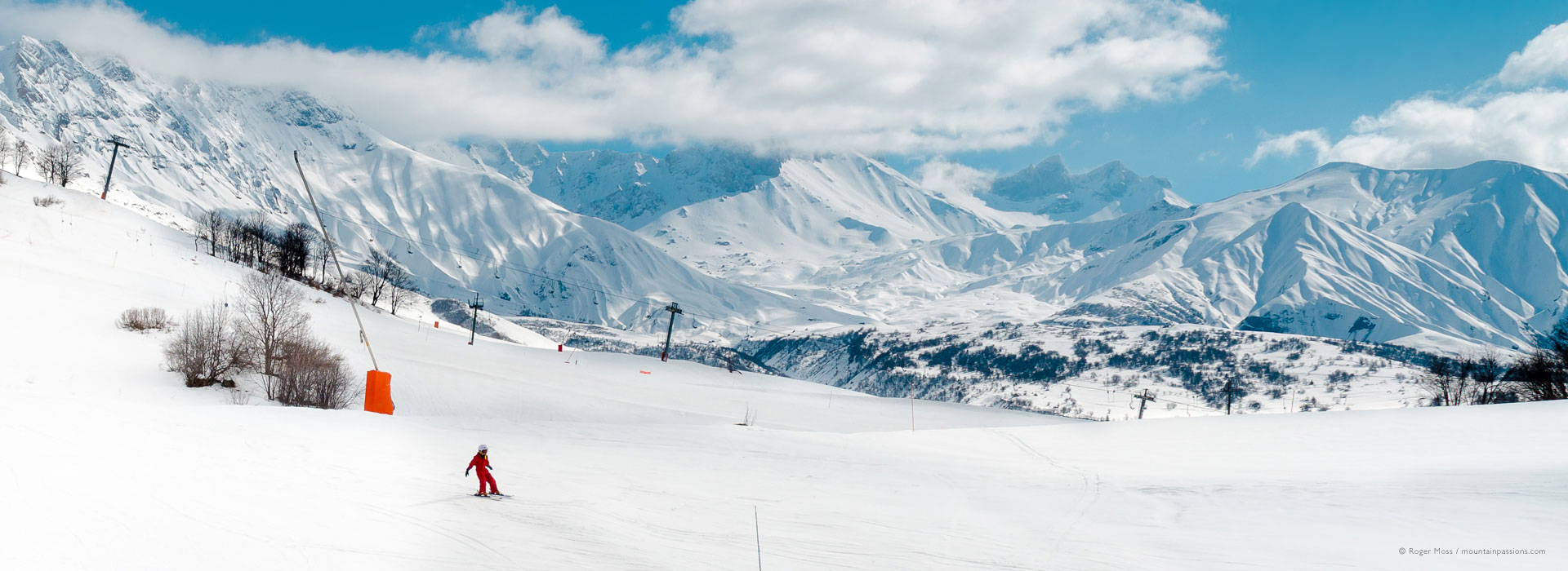 Albiez-Montrond in France - a person skiing down a snow covered mountain.