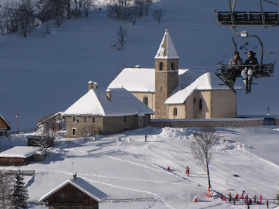 A winter sports scene at Albiez-Montrond in Savoie Mont Blanc France featuring a ski resort a sports centre a ski lift and a chalet adding charm to the snowy landscape.
